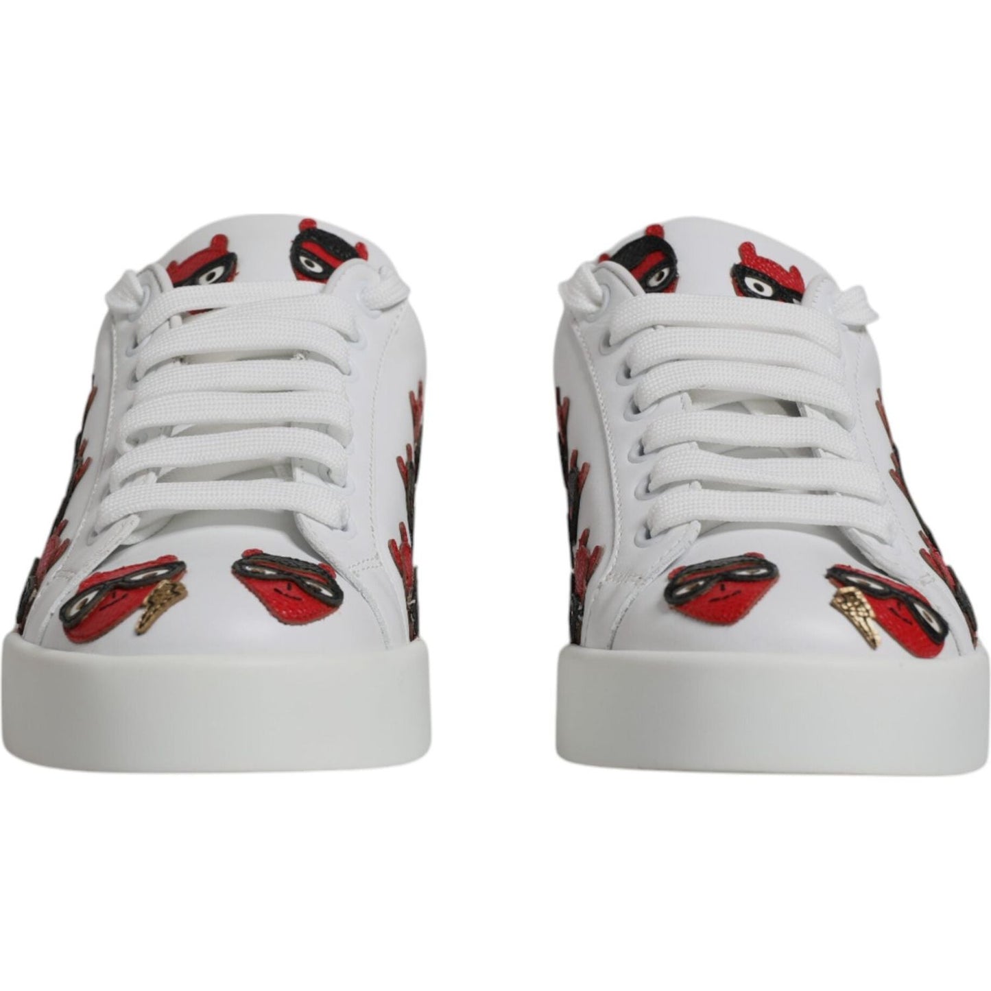 Dolce & Gabbana white sneakers with devil face design, red sole, crafted from 100% calf leather - front view.