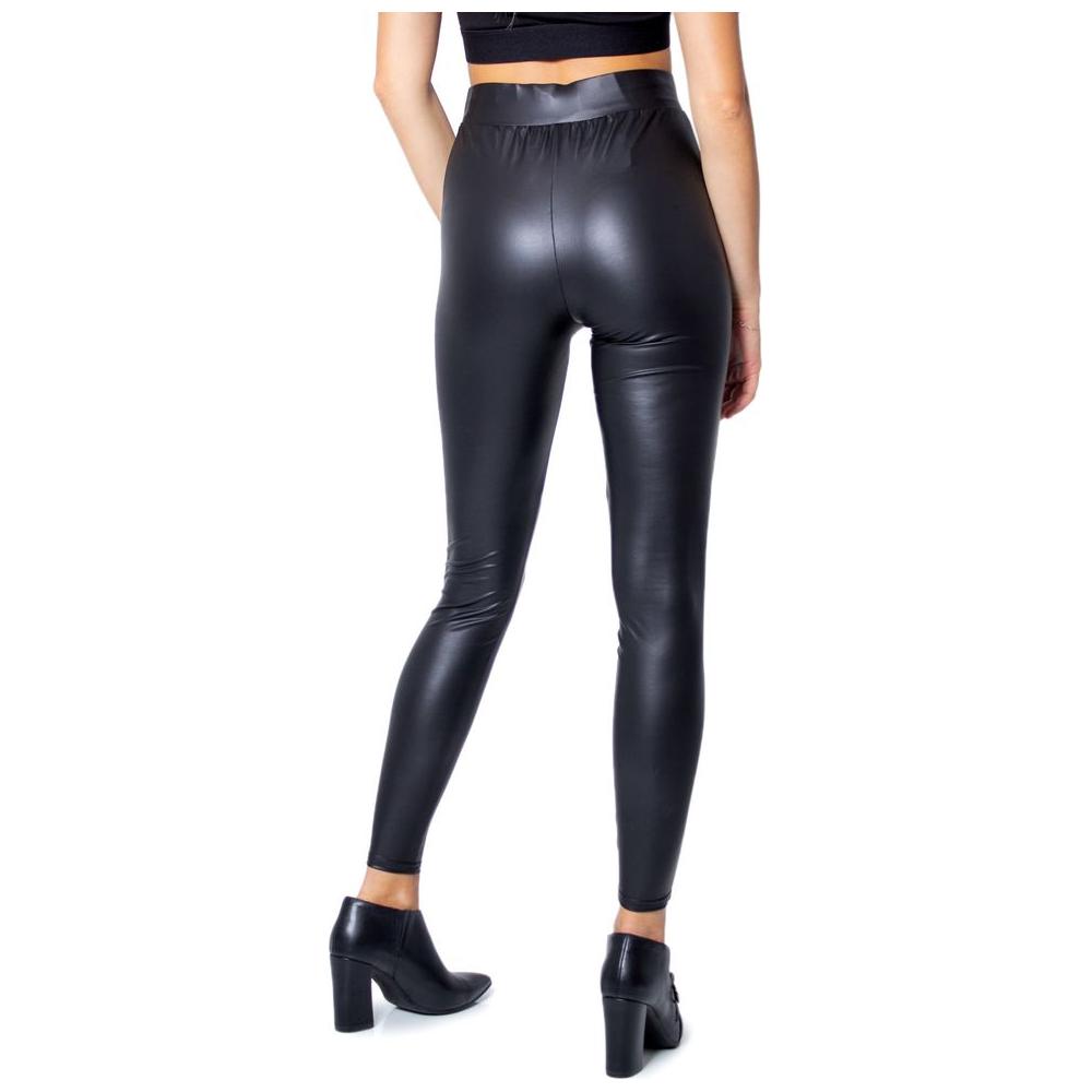 Back view of woman wearing glossy black polyester leggings with fitted design for casual or sophisticated occasions.