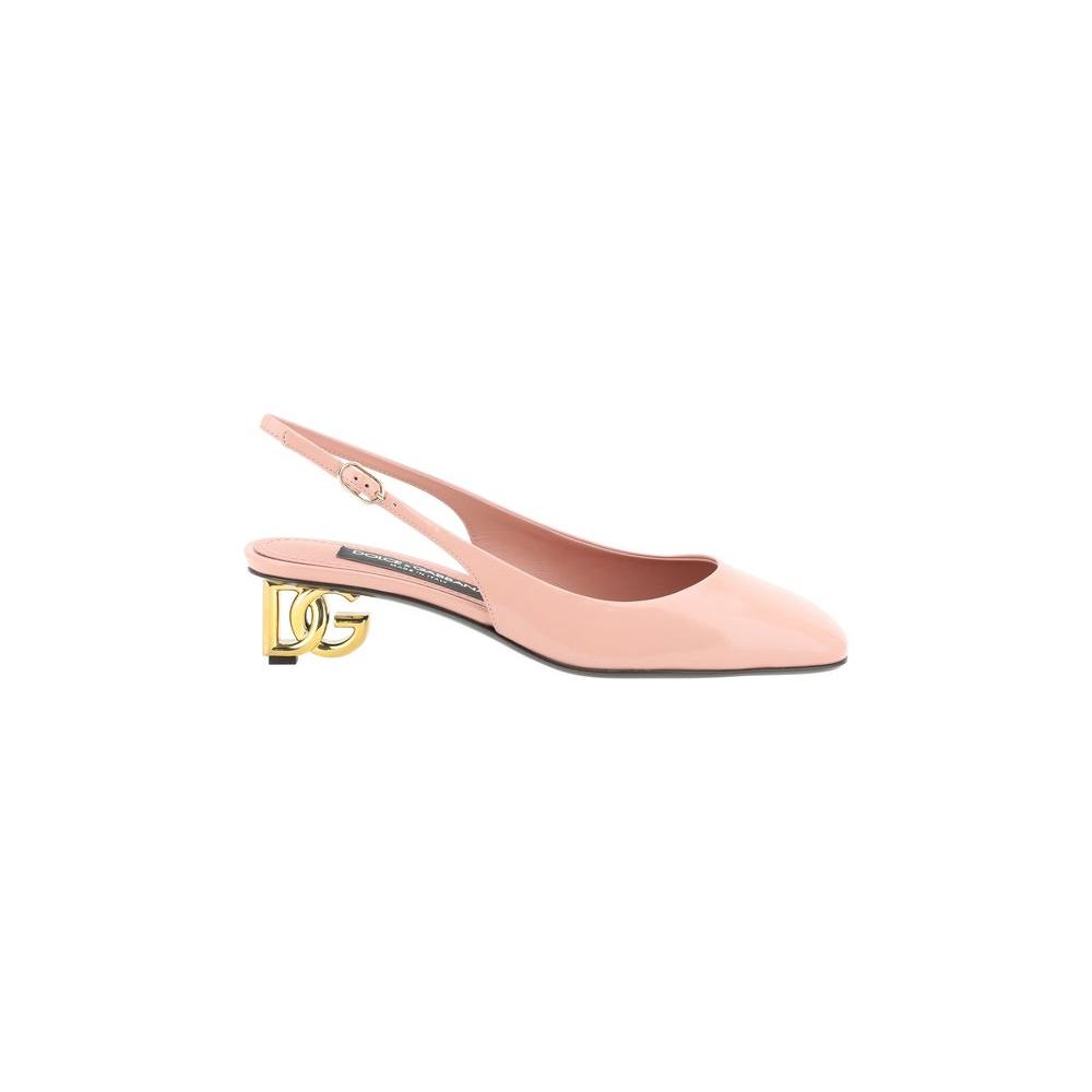 Dolce & Gabbana leather slingback pumps with golden D&G logo heel, featuring adjustable buckle and square toe, patent finish in blush pink.