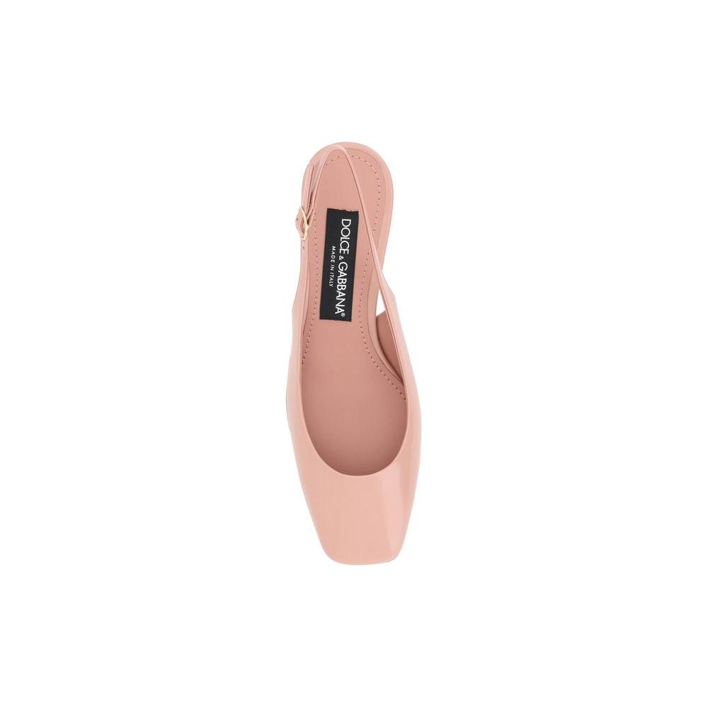 Top view of Dolce & Gabbana leather slingback pumps with square toe, featuring D&G logo on insole, in a blush pink patent leather finish.