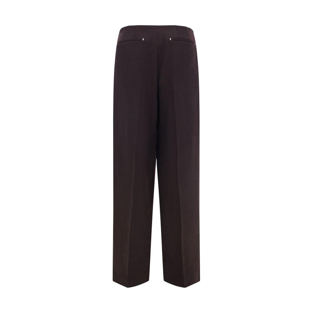 Back view of brown Fendi virgin wool pants with button and zipper closure, featuring side slash and rear welt pockets.