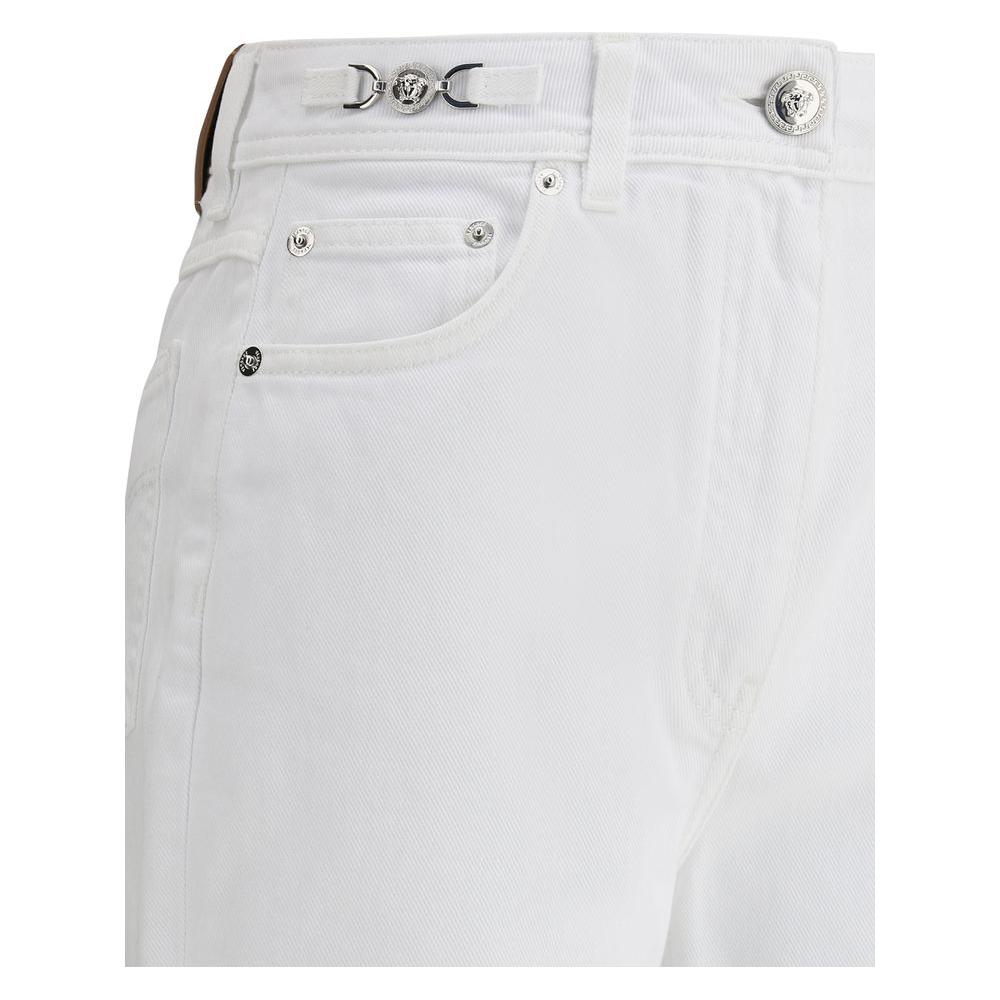 Versace white cotton jeans with high waist and Medusa logo detail, showcasing straight five-pocket design and luxurious craftsmanship.