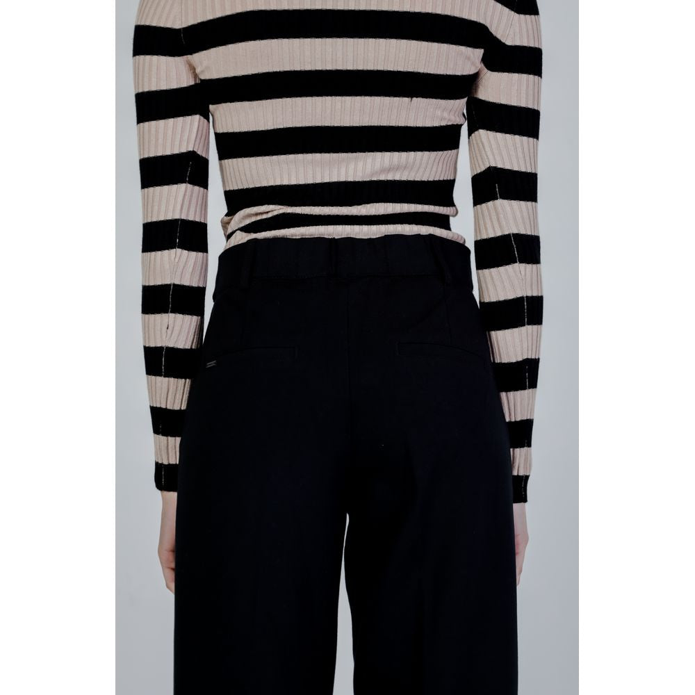 Woman wearing Street One black viscose palazzo pants, spring summer collection, back view showing style and fit.