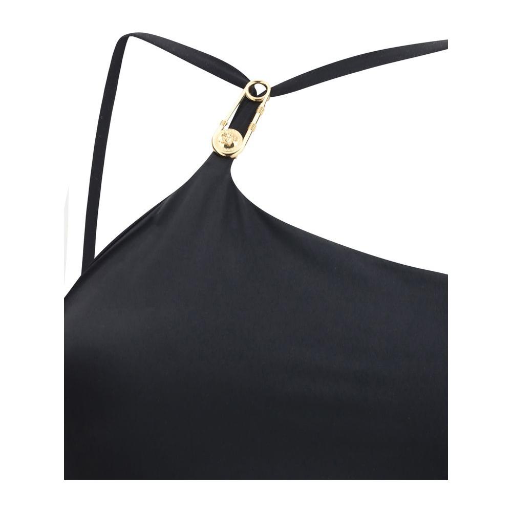 Versace swimsuit with iconic Medusa logo plaque, deep back neckline, and monochrome pattern detail.