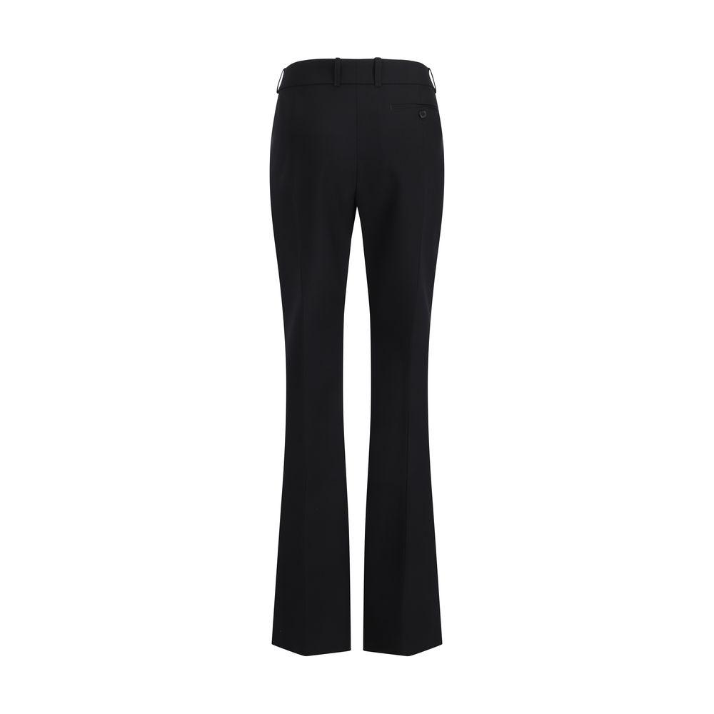 Back view of Alexander McQueen wool pants with monochrome pattern, leather patch, side and buttoned back pockets, and regular fit.