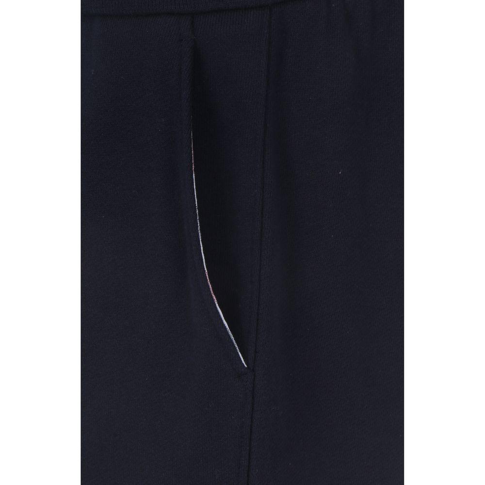 Close-up of Thom Browne sweatpants featuring front welt pocket and iconic design elements.