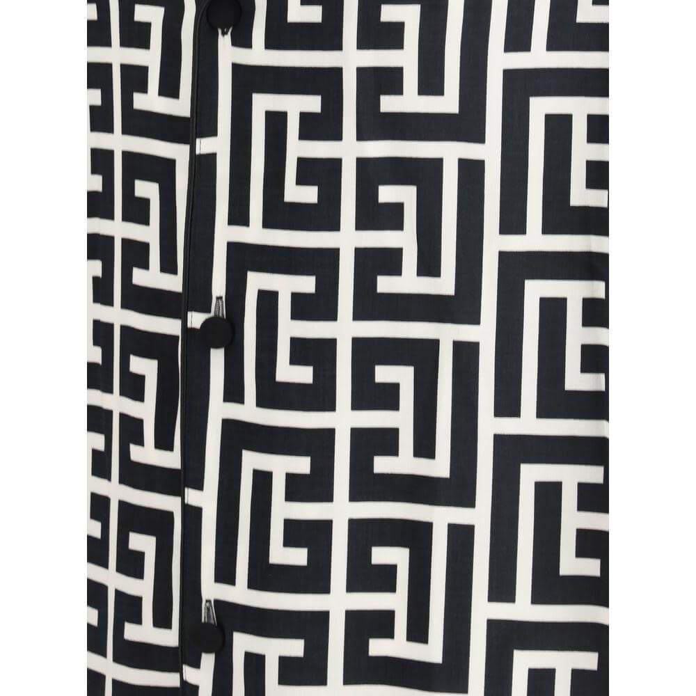 Close-up of Balmain shirt fabric featuring a black and white geometric repeated pattern design. Fashion detail.