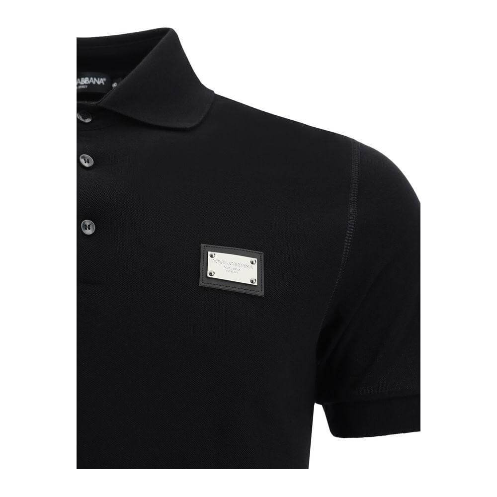 Black Dolce & Gabbana polo shirt with ribbed collar, tone-on-tone buttons, and D&G metal plaque on the front.