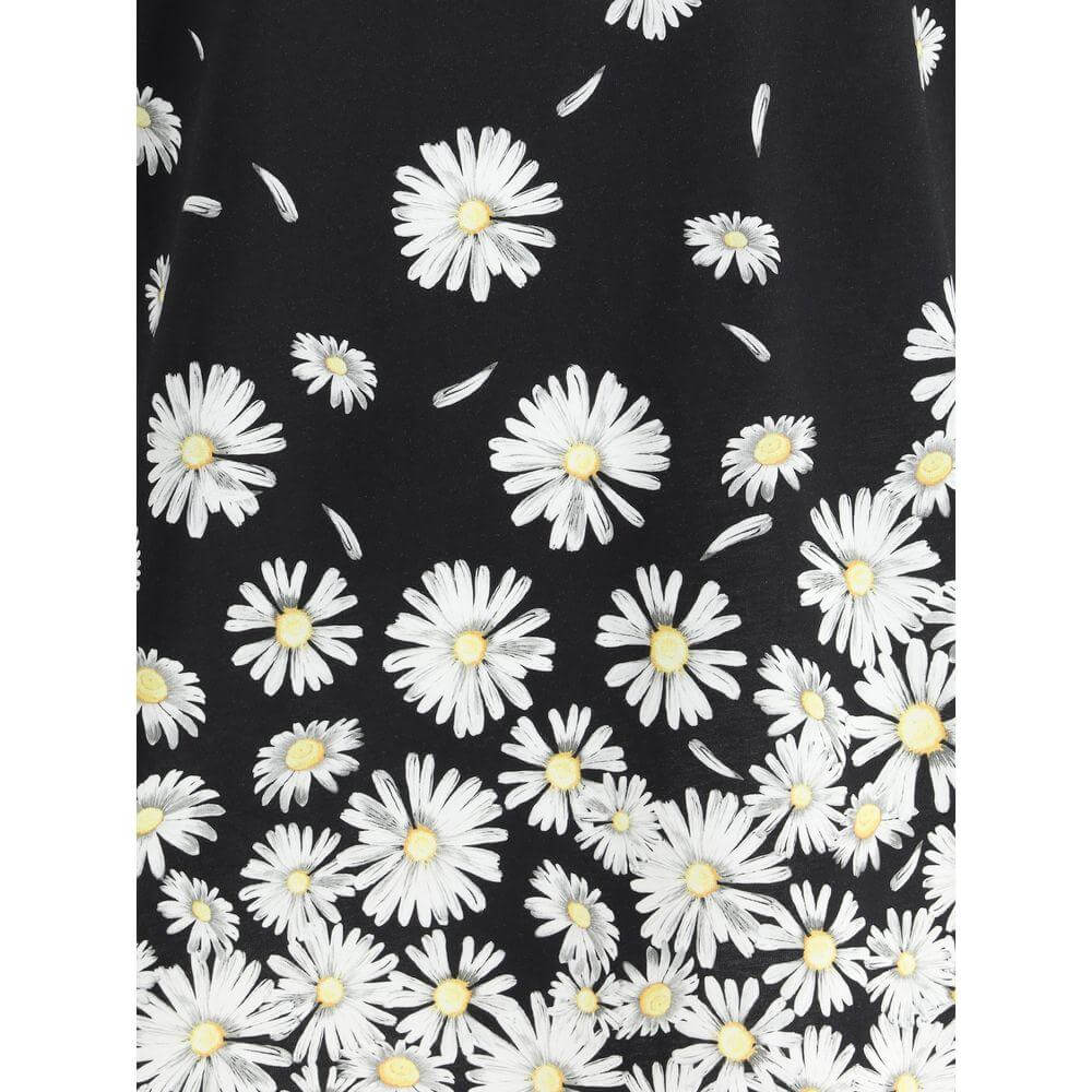 Close-up of Moschino Daisies T-Shirt with vibrant white daisy print on black fabric, showcasing playful floral design.