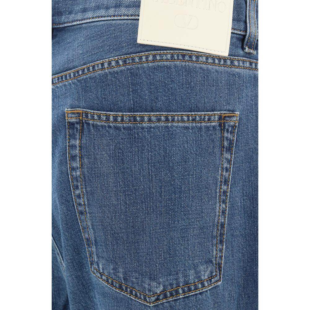 Valentino cotton jeans featuring five-pocket design, straight style, and iconic leather patch with brand signature on back waistband.