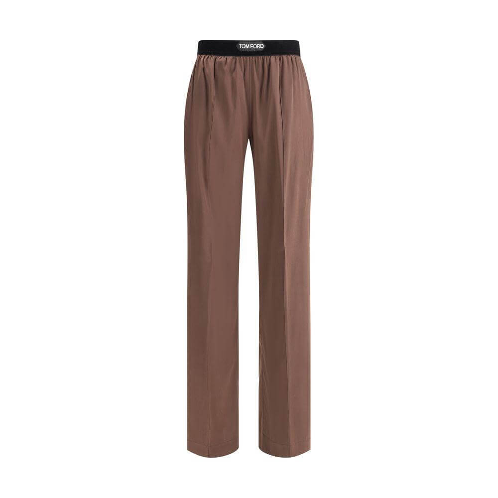 Tom Ford silk pants with elastic waistband, front slash pockets, and rear patch pockets; logo on waistband.