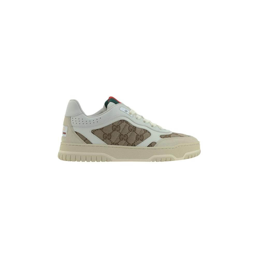 Gucci calfskin sneakers with textured panels, lace-up front, round toe, platform sole, and iconic GG logo fabric inserts.