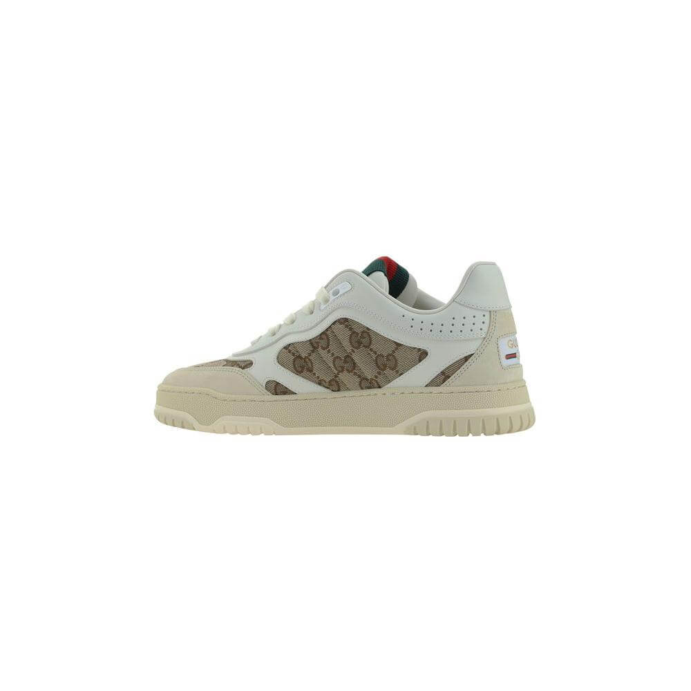 Gucci calfskin sneakers with textured panel design, lace-up front, round toe, platform sole, and contrasting GG logo fabric inserts.