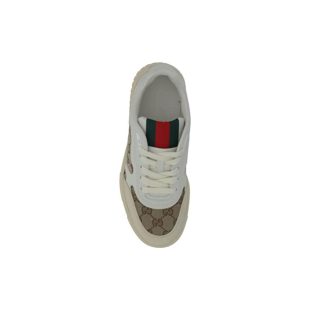Top view of Gucci calfskin sneakers with lace-up design, textured panels, round toe, and GG logo fabric inserts.