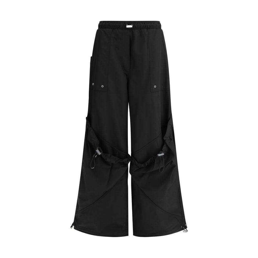 The Attico black nylon cargo pants featuring adjustable drawstring waistband and multiple pockets for urban style and functionality.