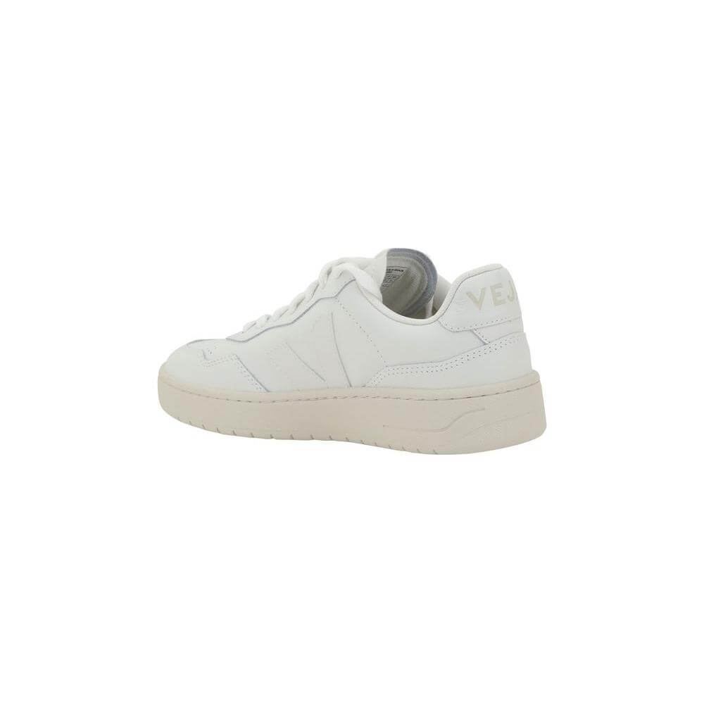 Veja V-90 organic leather sneakers in white, showing side view with V logo patch and round toe, offering minimalist and modern style.