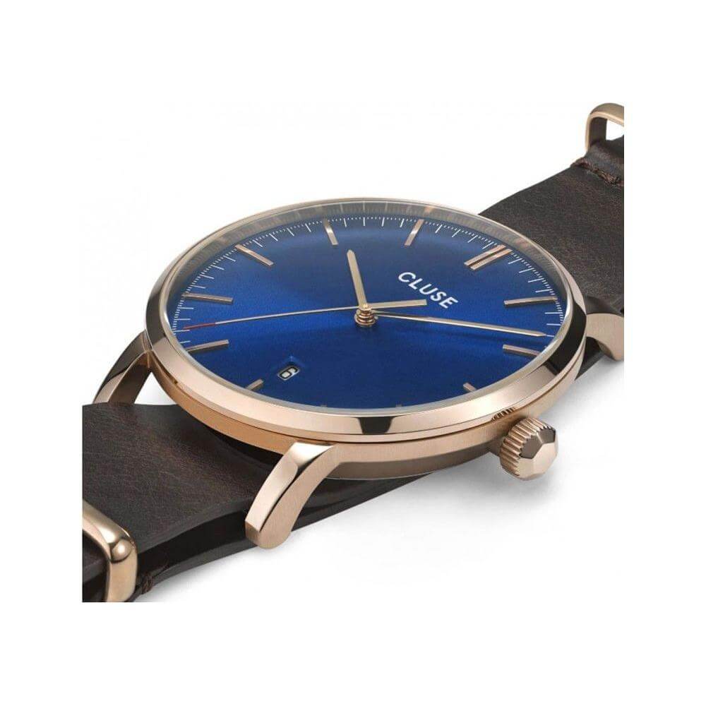 Cluse brown leather watch with blue dial, quartz mechanism, stainless steel case, and buckle closure. Water resistant up to 3 ATM.