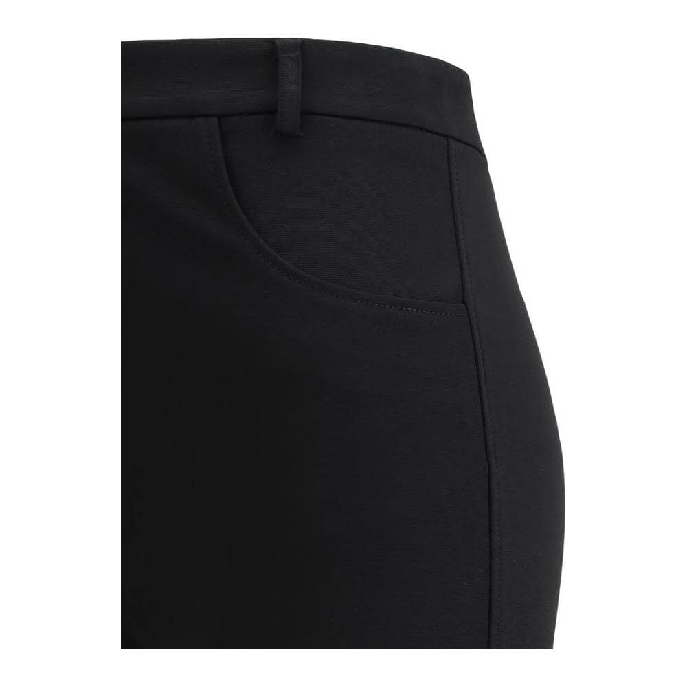 Close-up of The Andamane boot-cut pants showing front welt pocket and classic fit in black fabric.