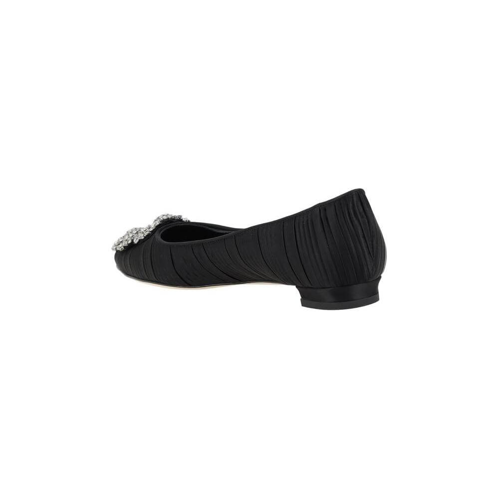 Side view of Manolo Blahnik Hangisiflat Ballerinas in black silk satin with Swarovski jewel detail and pleated design.
