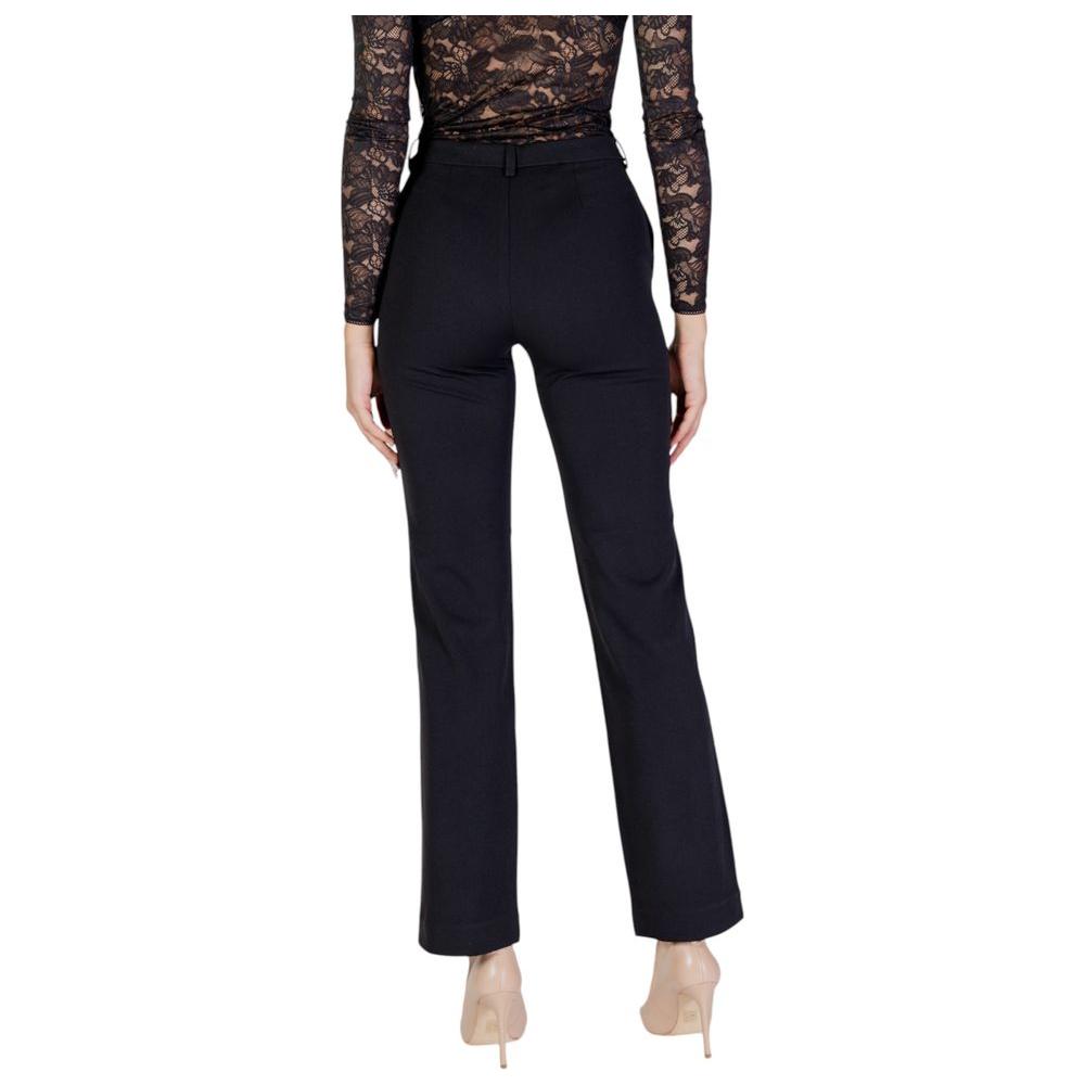 Alt Tag: Women's fall/winter black recycled polyester pants, back view, made from 53% recycled materials for sustainable fashion.