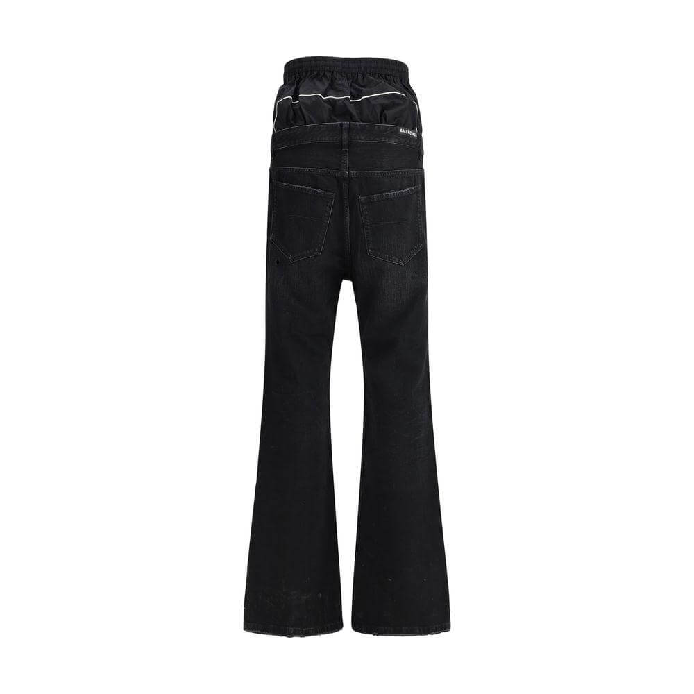 Back view of Balenciaga Layered Jeans with double-layered waist, elastic waistband, and five-pocket design in black.
