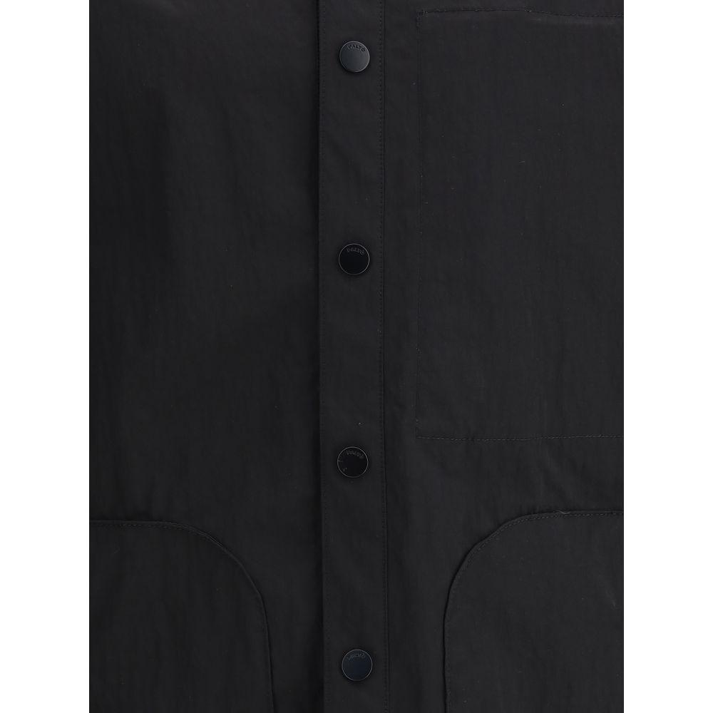 Close-up of Paltò Gilberto shirt jacket showing button closure and elegant design in black fabric.