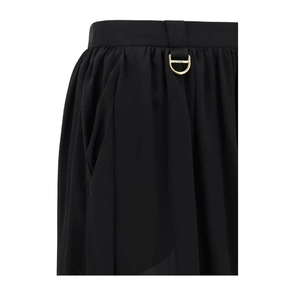 Close-up of Chloé Silk Pants featuring a side zipper, belt loops, and wide Arabian-style pattern for an elegant silhouette.