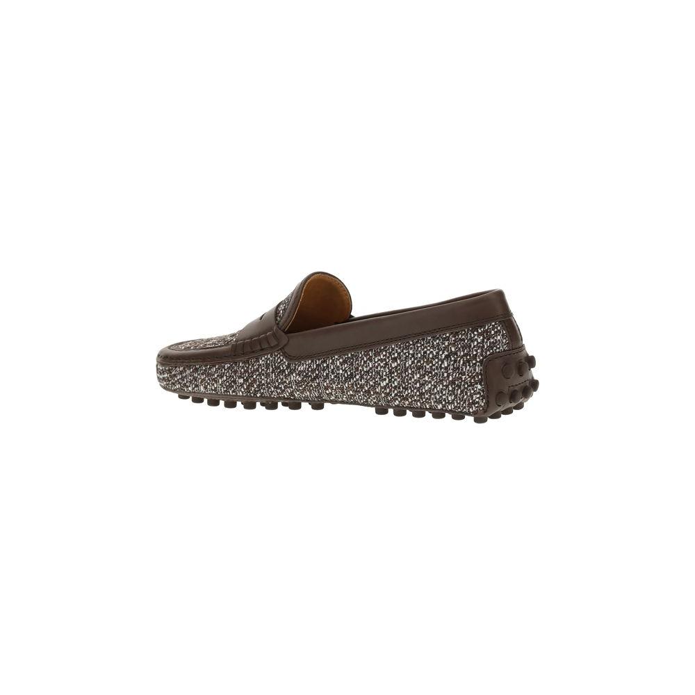 Side view of Tod's Tweed Gommino Loafers with leather trim and non-slip rubber lugs, showcasing sophisticated design and durability.