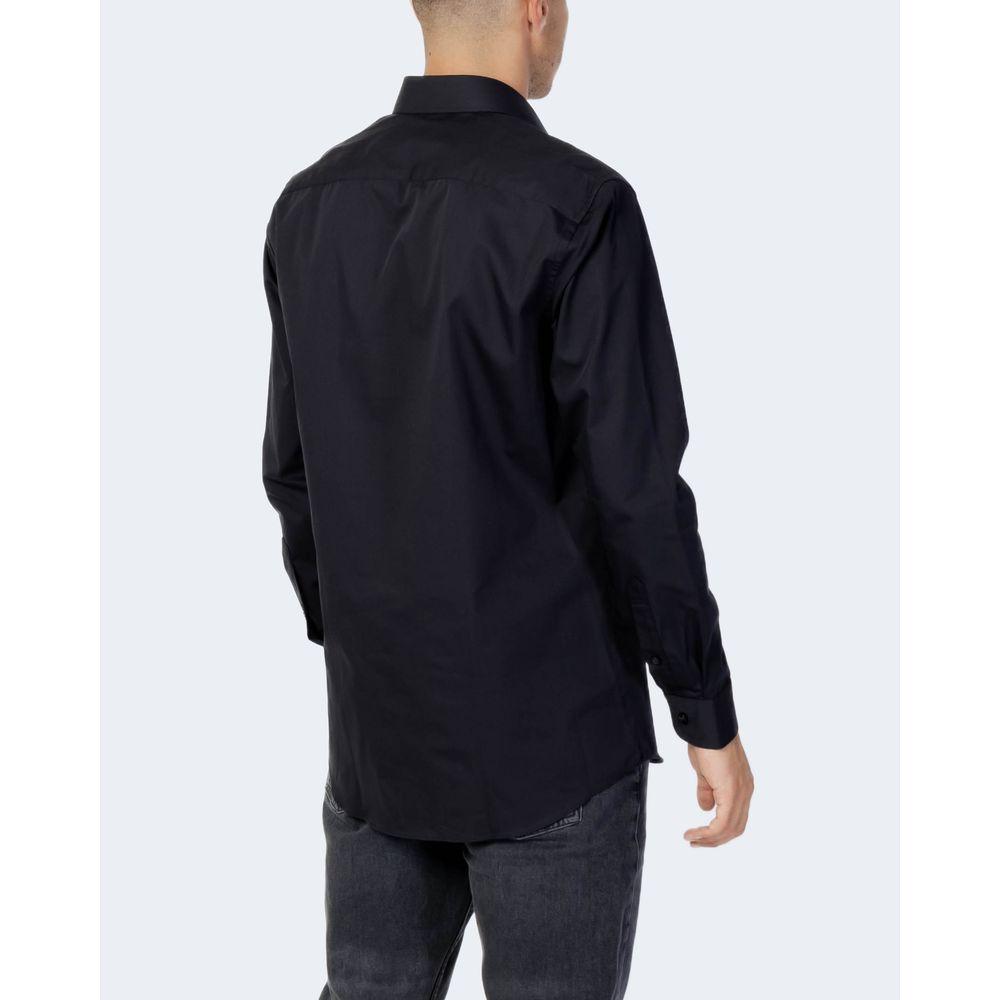 Man wearing selected black cotton long-sleeve shirt with contrasting buttons, viewed from the back, ideal for formal and casual wear.
