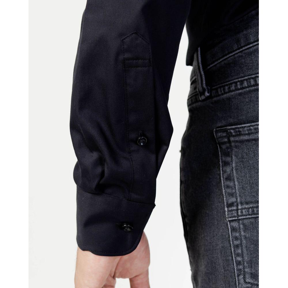 Close-up of Selected Black Cotton Shirt sleeve with contrasting buttons and denim jeans, showcasing refined craftsmanship and style.