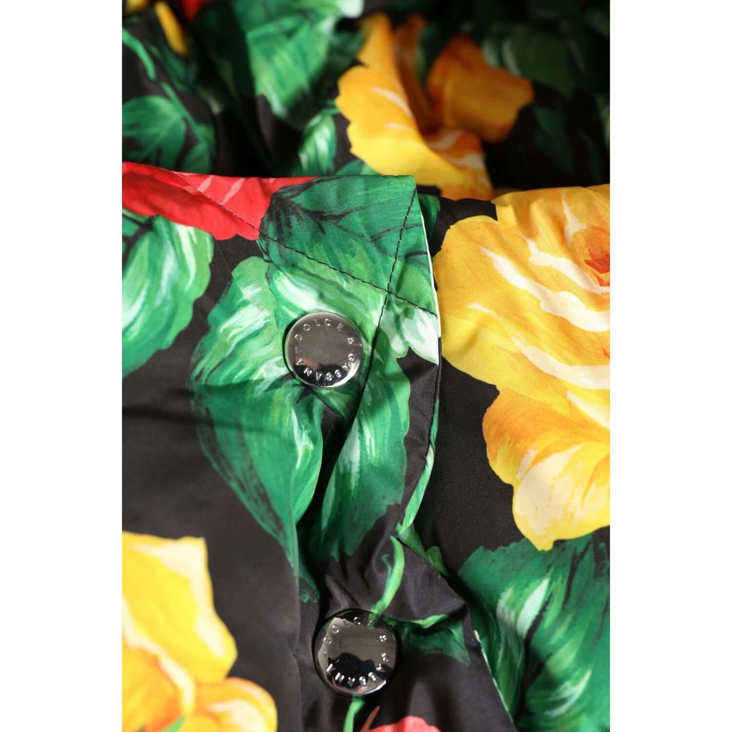 Close-up of Dolce & Gabbana multicolor floral print on polyester head wrap hat with button details, vibrant yellow roses.