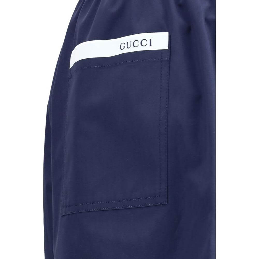 Navy Gucci shorts with logo, featuring side pocket and adjustable waistband, offering comfort and timeless elegance.