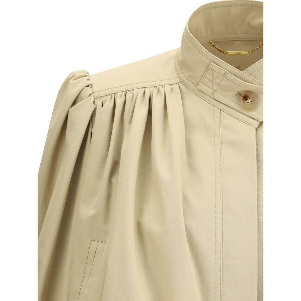 Chloé cropped jacket with mandarin collar, ruffle details, and hidden flap buttons in cotton fabric; close-up view of the modern design.