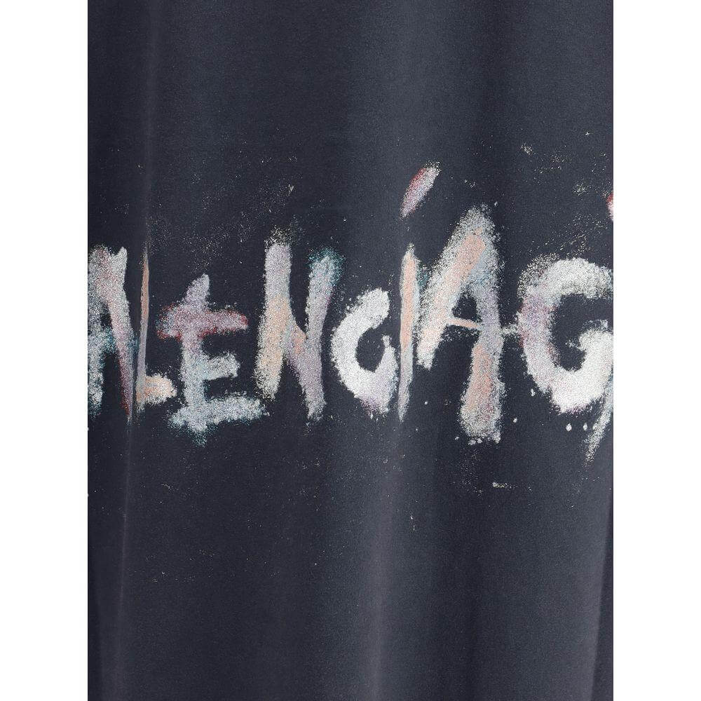 Balenciaga oversized T-shirt featuring a glittery monogram design on black cotton fabric, combining vintage style and modernity.
