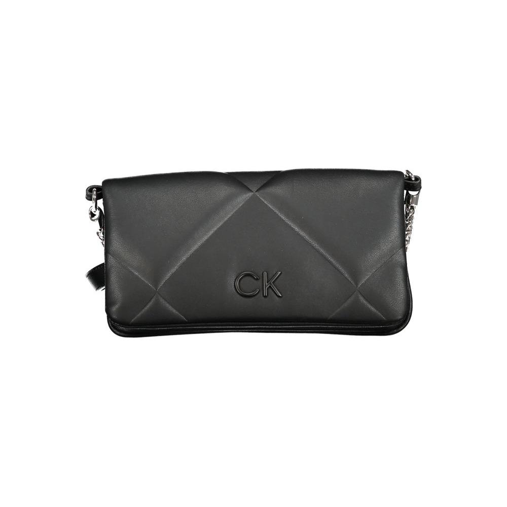 Calvin Klein black cotton handbag with chain shoulder handle and adjustable belt, features magnetic closure and logo.