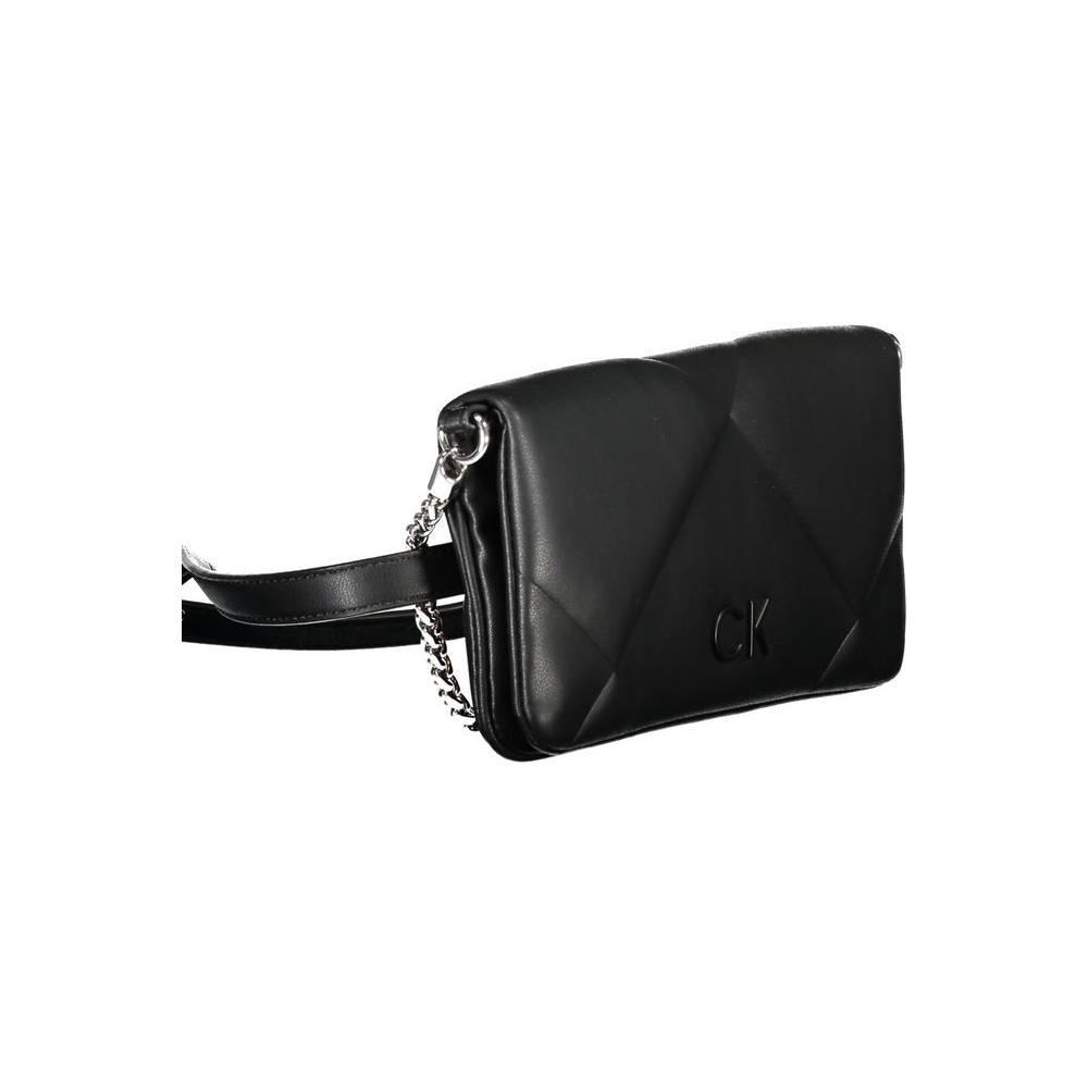 Calvin Klein black cotton handbag with chain shoulder handle, adjustable belt, magnetic closure, and logo detail.