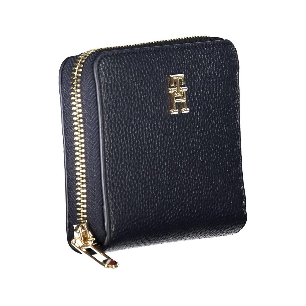 Tommy Hilfiger blue polyethylene wallet for women with zip closure and gold logo, featuring compartments and card slots.