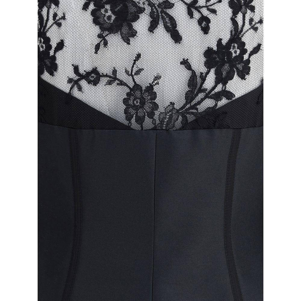 Alexander McQueen lace top with floral detailing and sleek black fabric, showcasing a chic and sophisticated design.