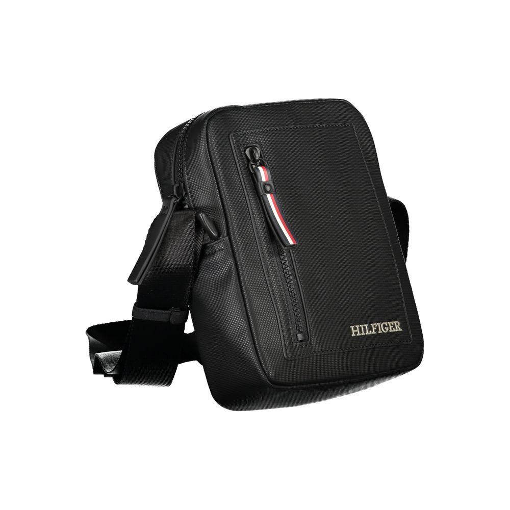 Tommy Hilfiger black shoulder bag with adjustable strap, external pocket, contrasting details, and zip closure.
