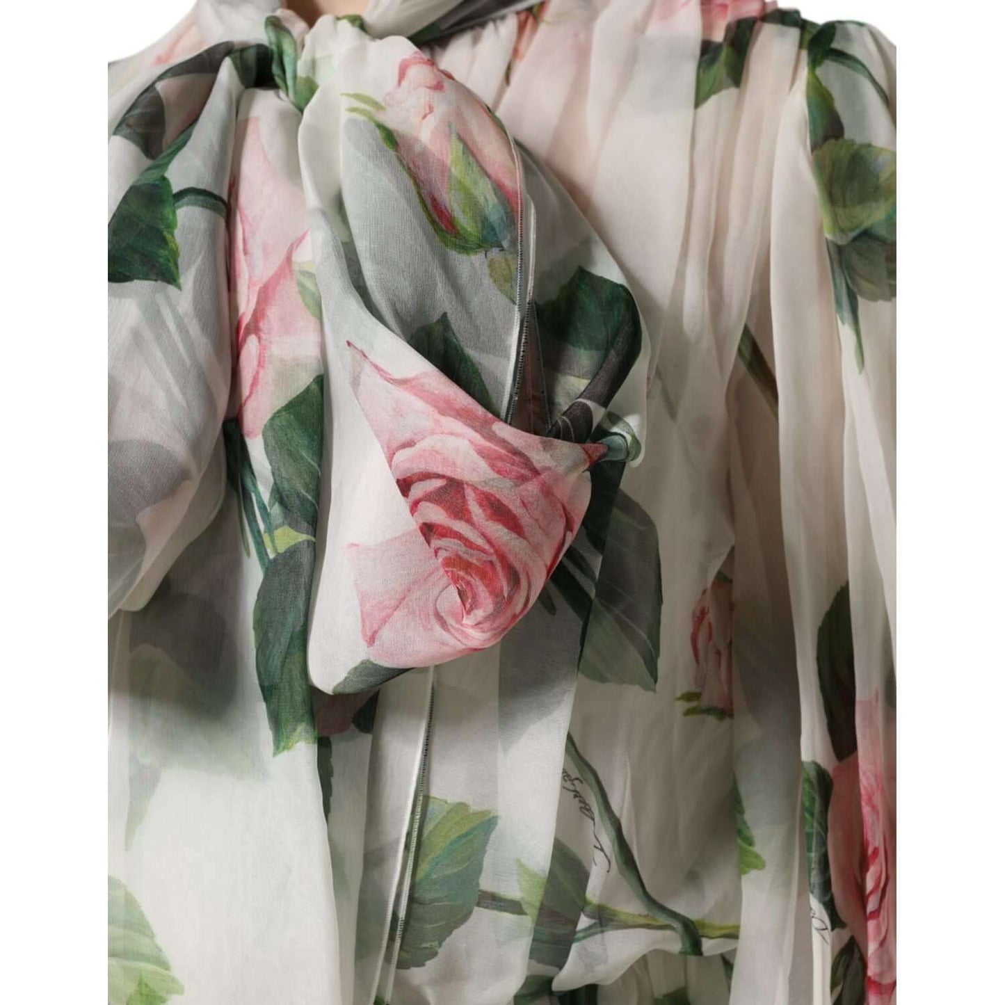 Dolce & Gabbana white maxi gown with pink rose print on silk fabric, highlighting elegant floral details and delicate fabric texture.