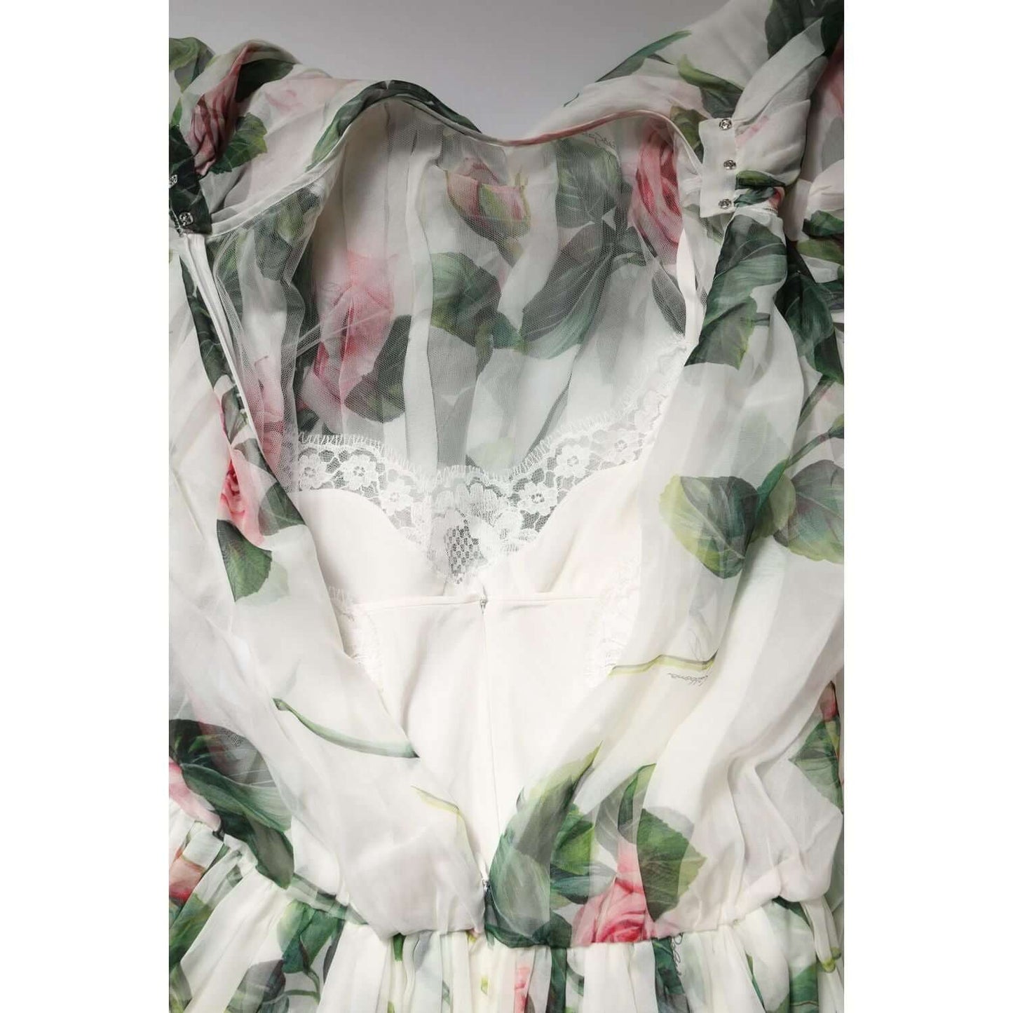 Dolce & Gabbana white floral maxi dress with pink rose print and lace detail, highlighting elegant silk fabric and intricate neckline.