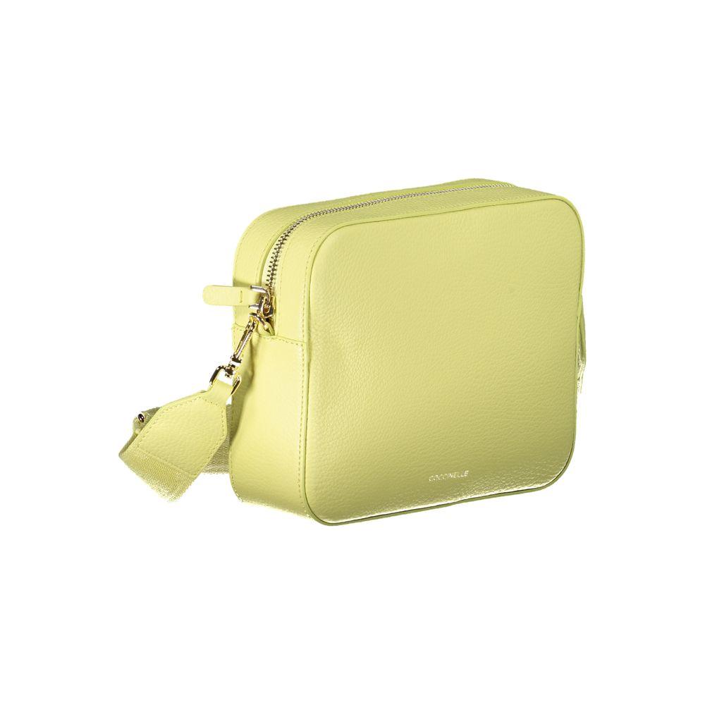 Coccinelle yellow leather handbag with adjustable shoulder strap, external and internal pockets, zip and swivel closure.