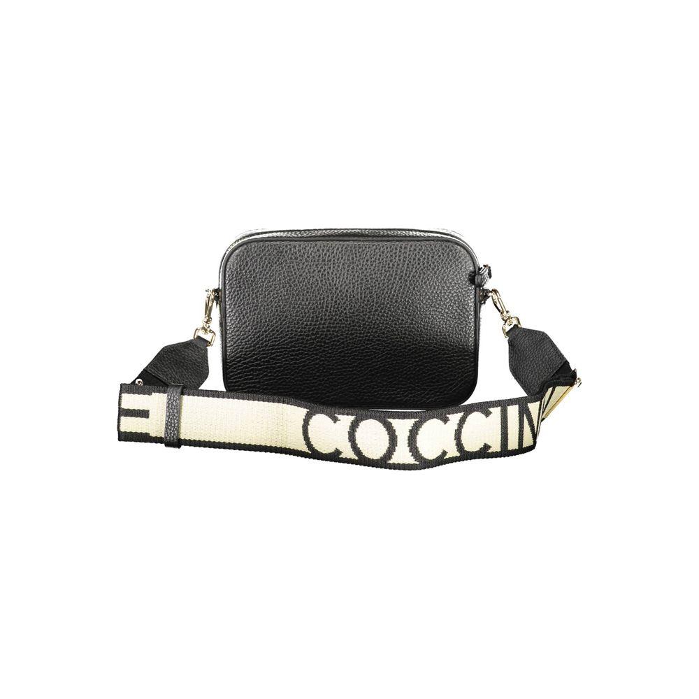 Coccinelle black leather handbag with adjustable and removable shoulder strap, contrasting details, and zip closure.