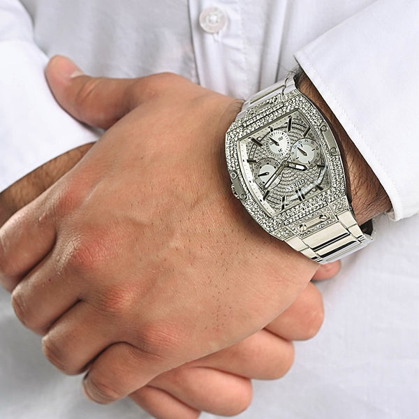 Gent wearing GUESS Mod. GW0094G1 wristwatch with silver analog design, quartz movement, and mineral dial