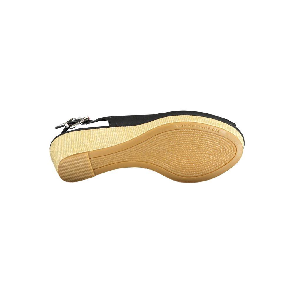 Bottom view of Tommy Hilfiger black leather sandal, showcasing sole design and ankle buckle closure.