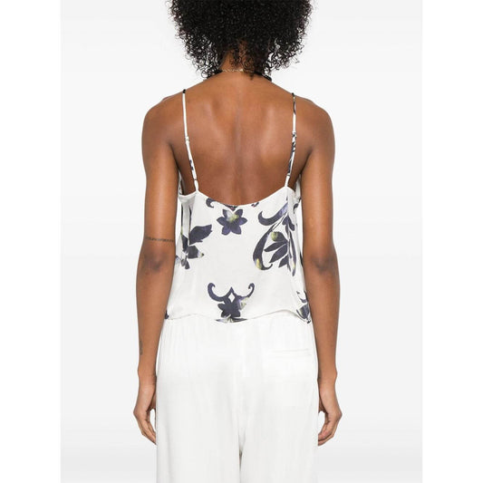 Back view of model wearing Forte Forte white printed top with spaghetti straps and scoop neck, paired with white bottoms.