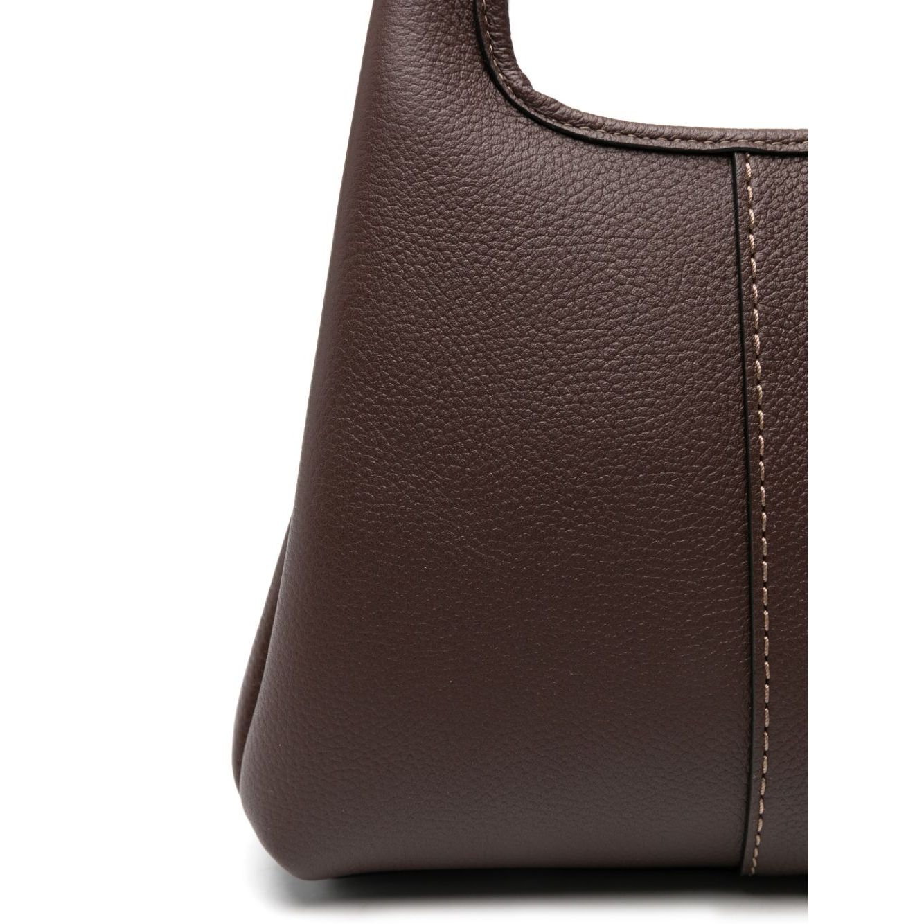 Close-up of Coach Lana 25 leather crossbody bag in coffee brown showing textured leather and stitch detail.