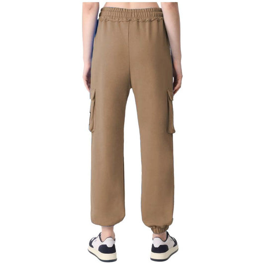 Rear view of Comme Des Fuckdown brown fleece pants with cargo pockets and an adjustable waistband, worn with sneakers.