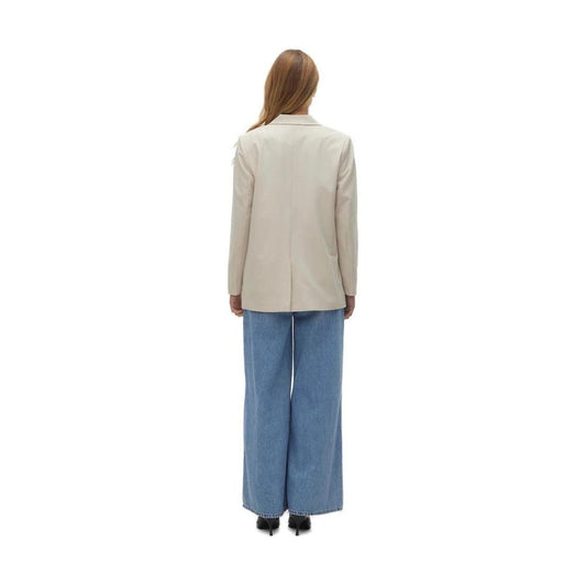 Back view of woman wearing Vero Moda beige polyester blazer, spring/summer collection, paired with wide-leg jeans, on white background.
