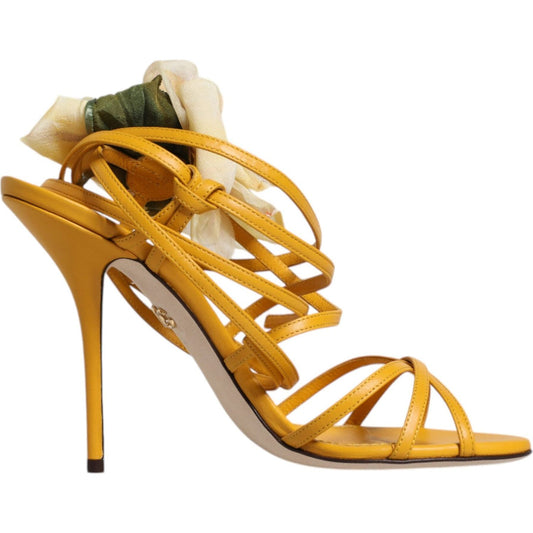 Dolce & Gabbana Keira sandals with yellow floral appliqué, adjustable ankle straps, stiletto heel, and leather sole, side view.
